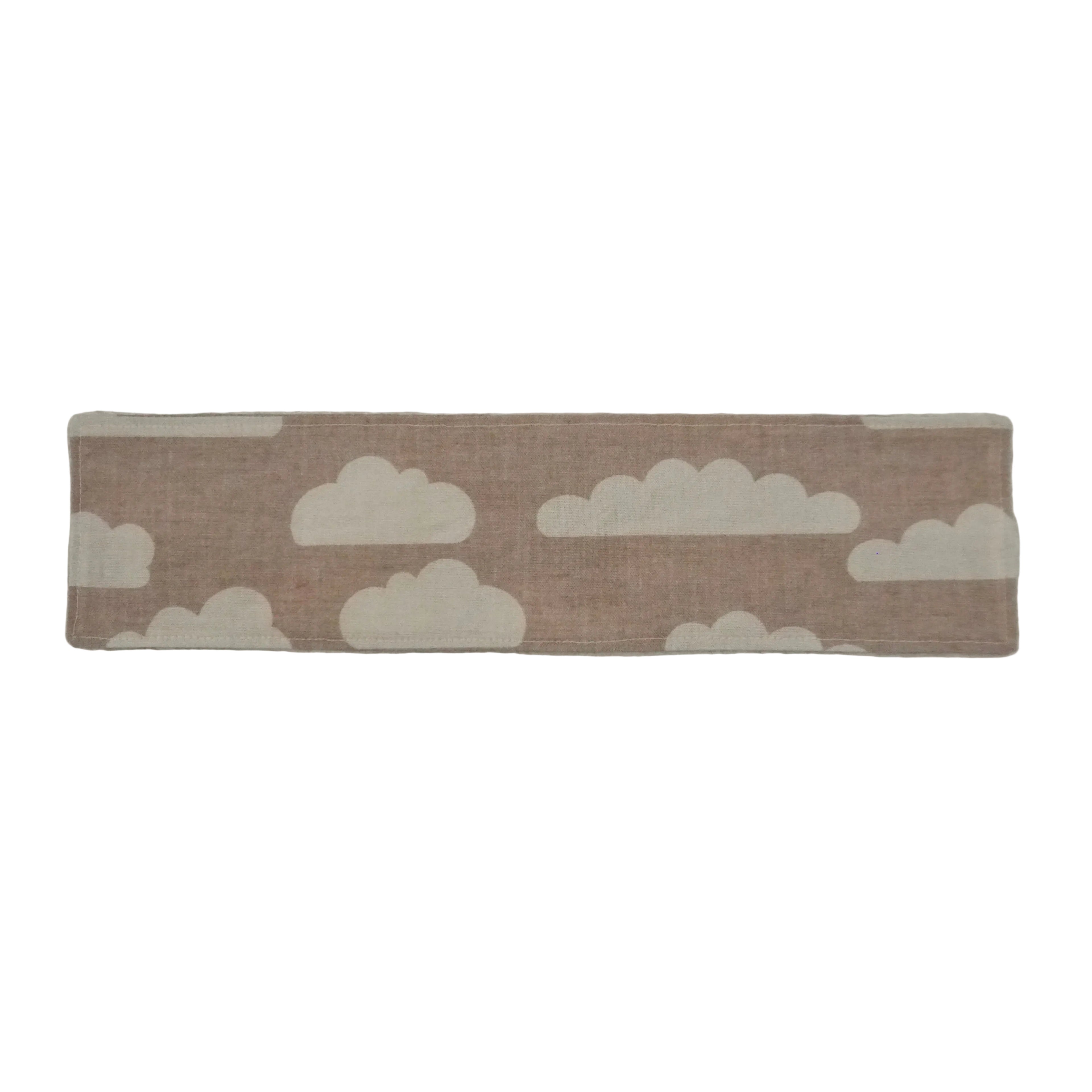 Beige fabric bookmark with white cloud pattern on a white background.