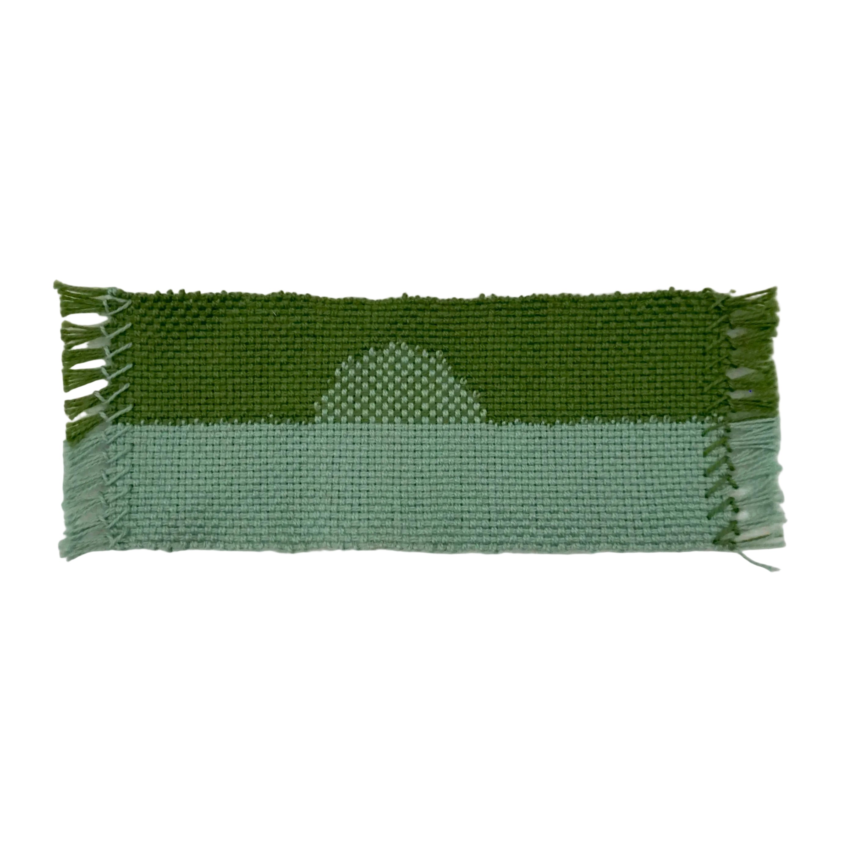 Green and blue woven bookmark with a half moon design on a white background.