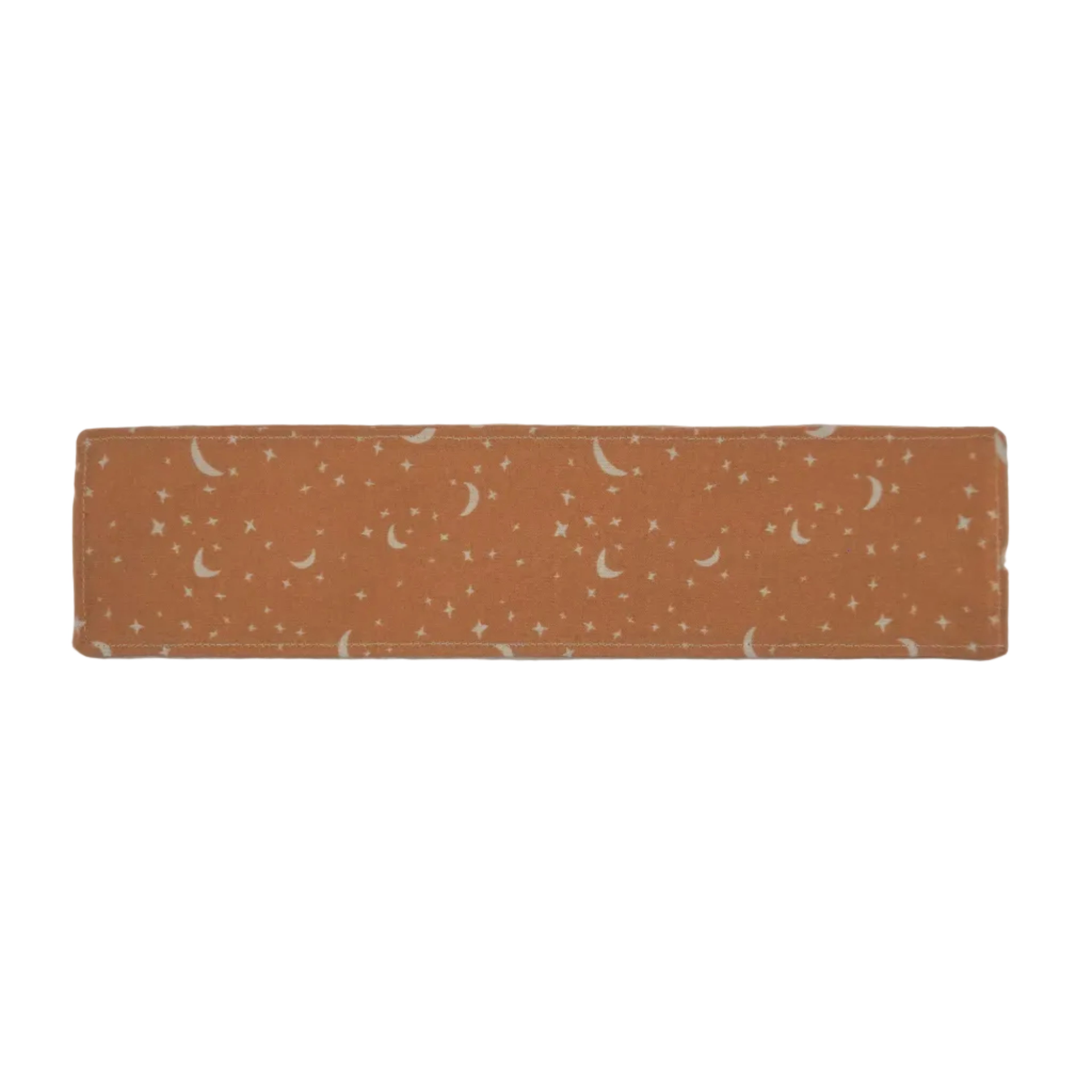 Light orange fabric bookmark with white moon and star pattern on a white background.