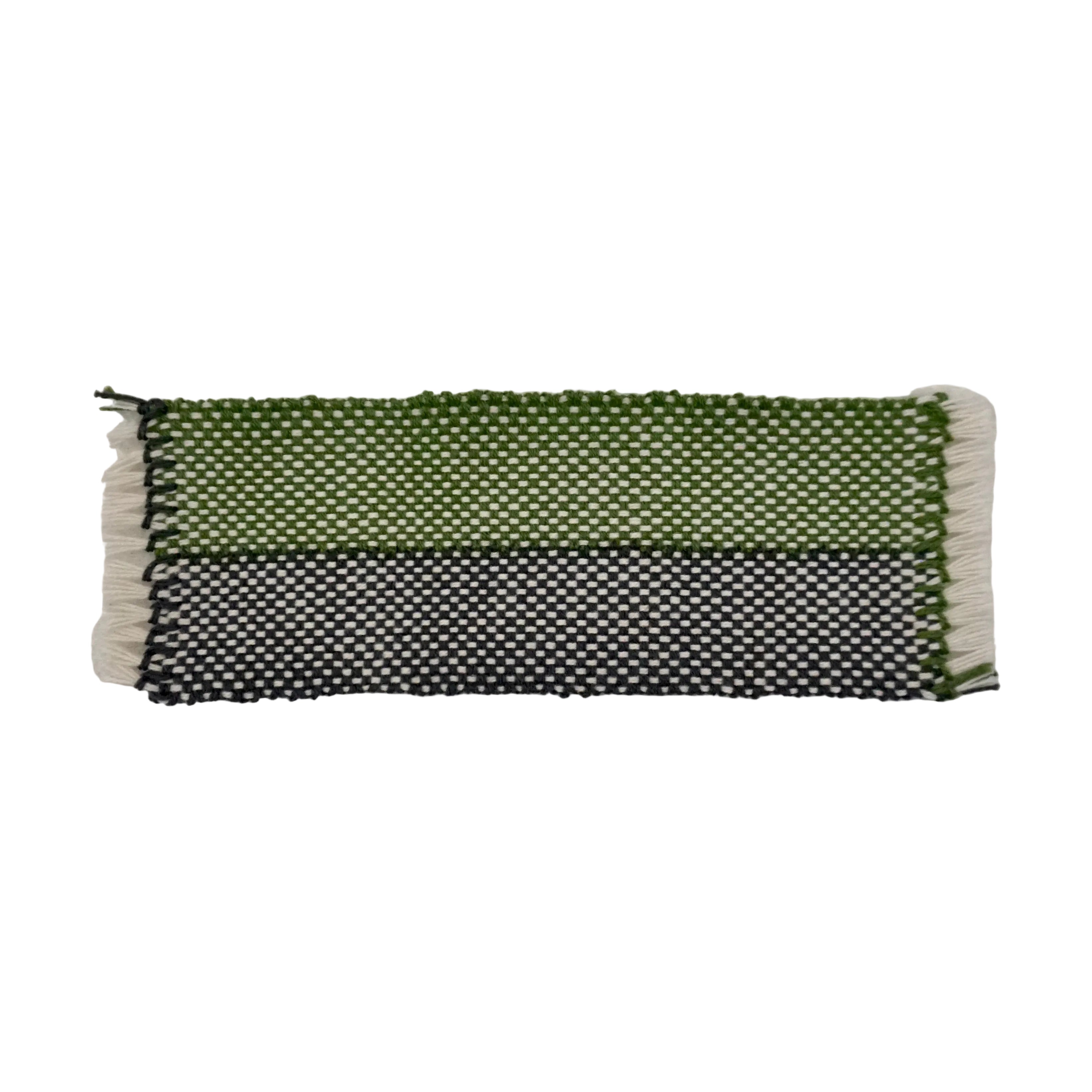 A green and charcoal gray woven bookmark with white accents featuring a stripe design on a white background.